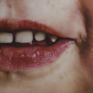 Hyperrealistic oil painting of a child's smile and facial details by Jan Petrov, from the Family Re-Construct series.