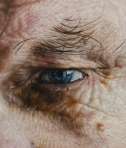 Hyperrealistic oil painting detail of a blue eye with intricate skin texture by Jan Petrov.